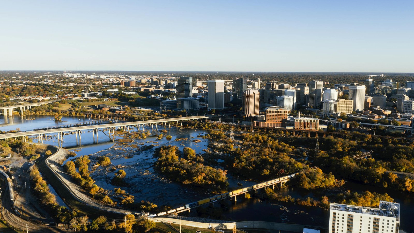 A breathtaking aerial shot of Richmond's skyline and river on a sunny day.
