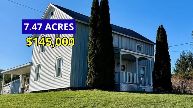 Exterior view of a 1928 brick farmhouse on 7.47 stream-fed acres for sale at $145,000 in Afton, New York