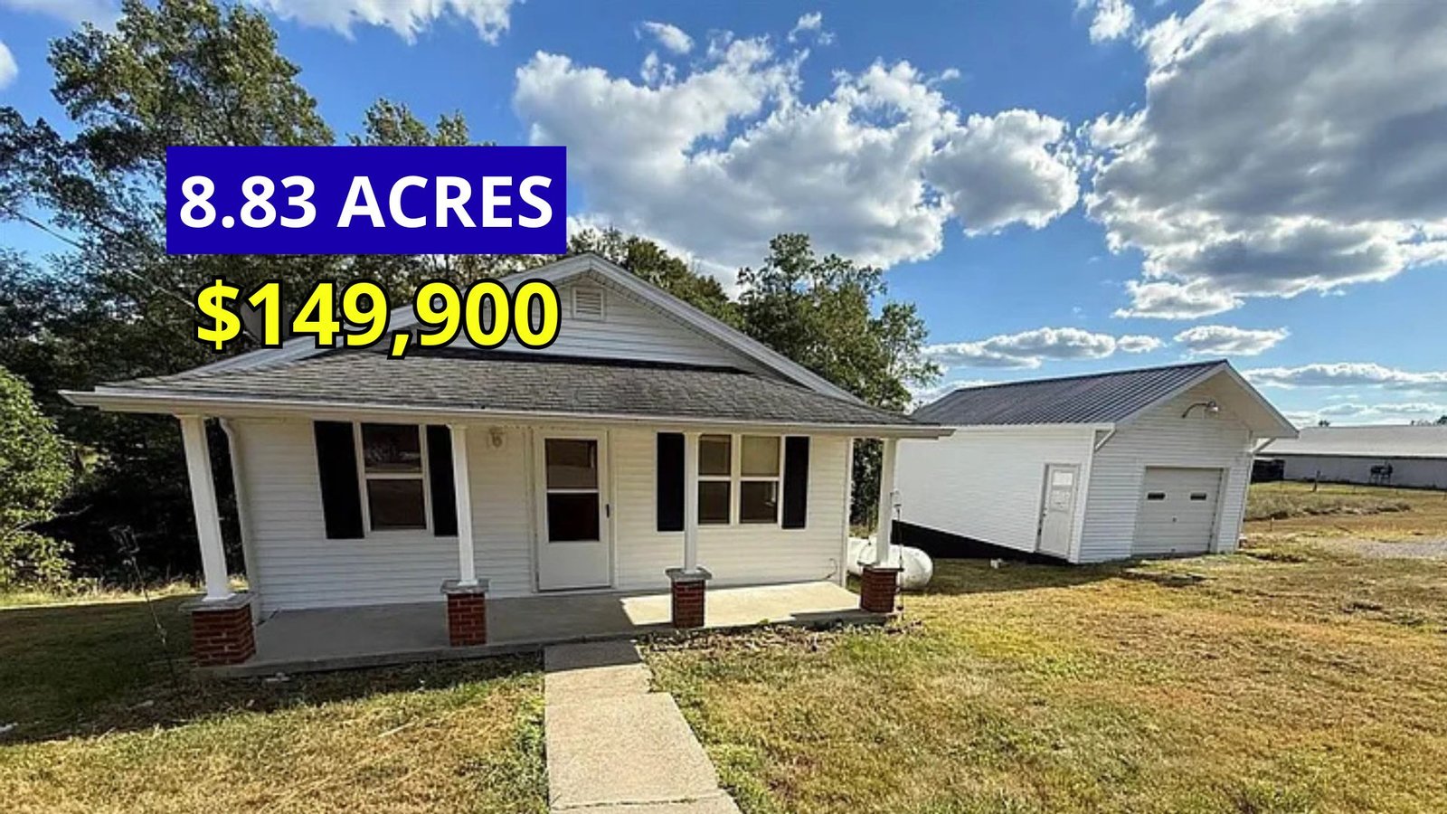 Exterior view of a rural farmhouse on 8.83 acres for sale at $149,000 in Elk Horn, Kentucky