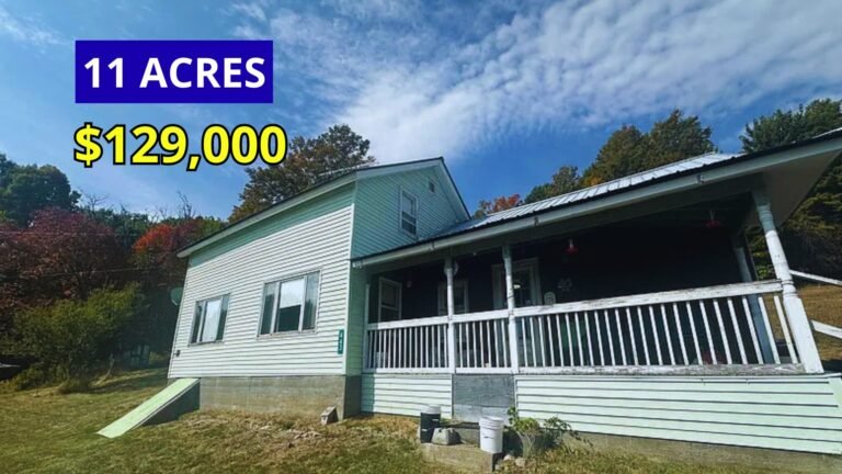 Exterior view of an 1887 farmhouse on 11 acres with lake and mountain views for sale at $129,000 in Moriah, New York in the Adirondacks
