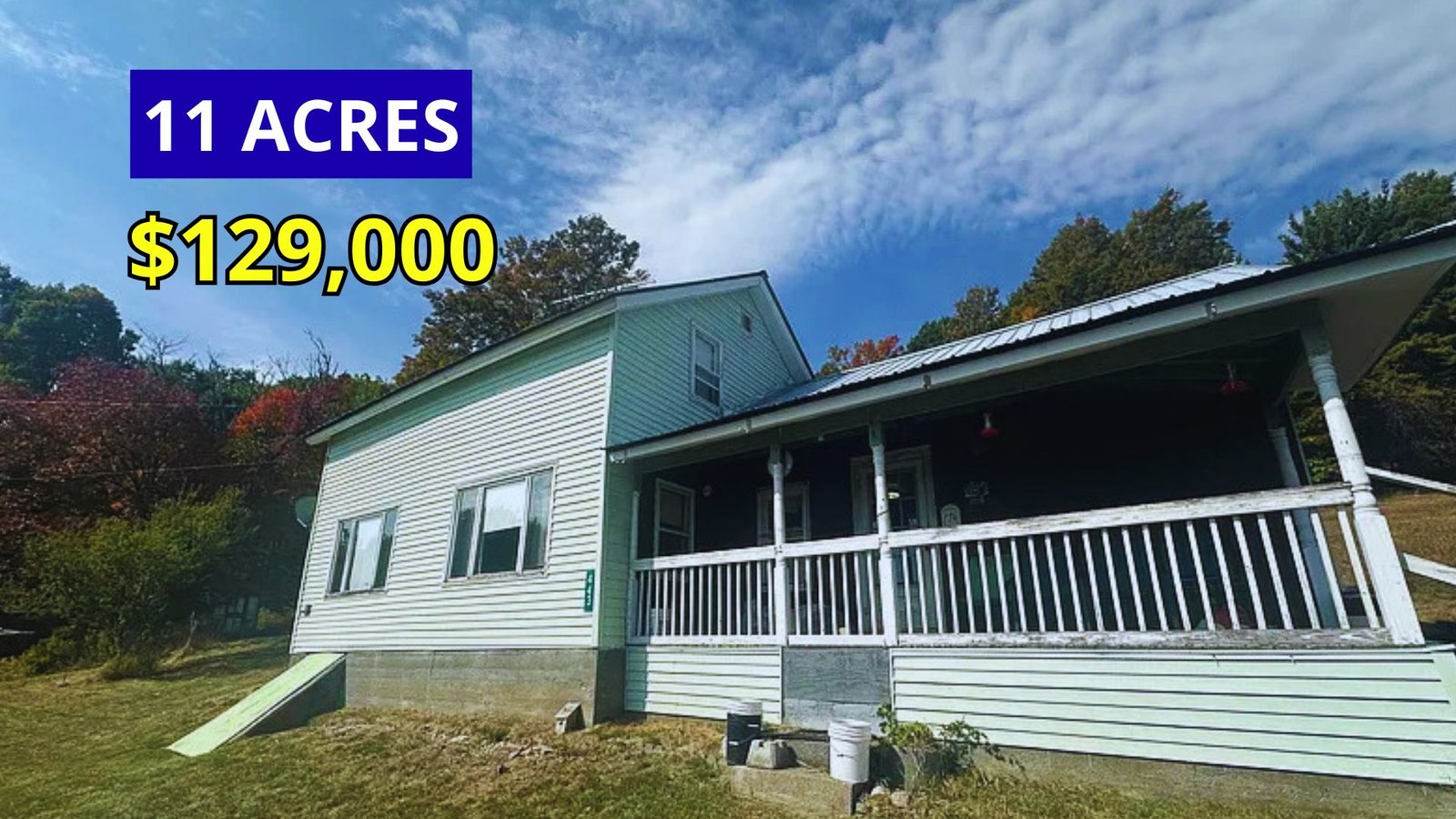 Exterior view of an 1887 farmhouse on 11 acres with lake and mountain views for sale at $129,000 in Moriah, New York in the Adirondacks