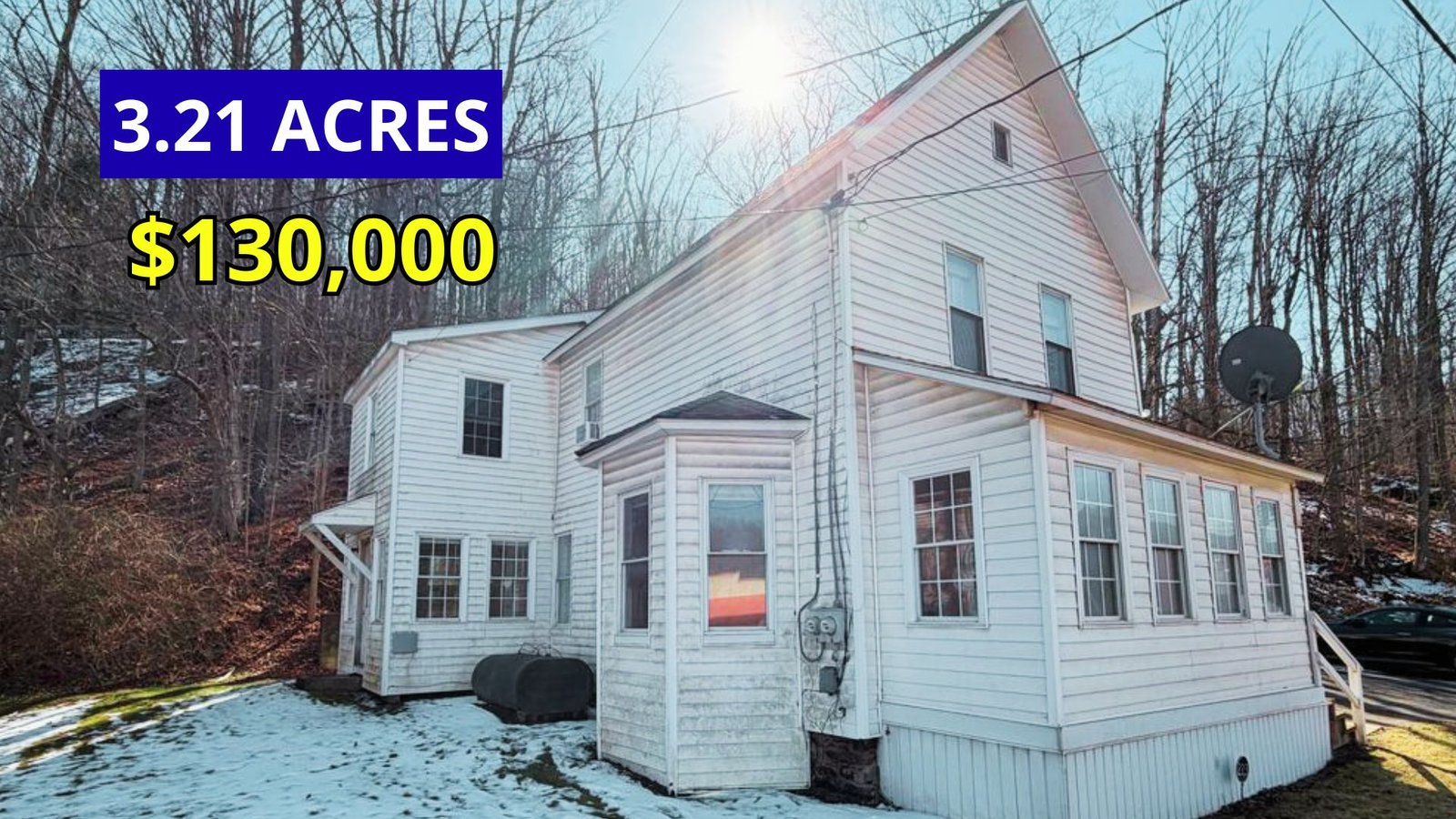 Exterior view of a two-story home on 3.21 acres with public water and sewer for sale at $130,000 in Dushore, Pennsylvania