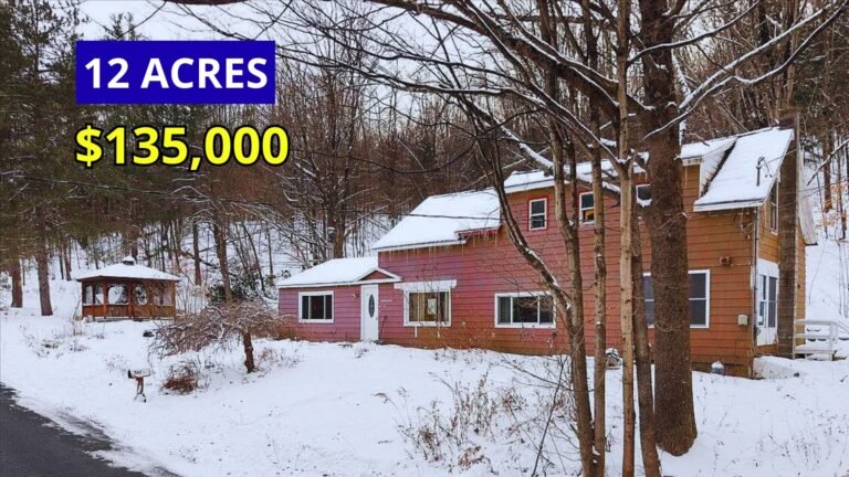 Exterior view of a farmhouse on 12 wooded acres with established homestead plantings for sale at $135,000 in Petersburgh, New York