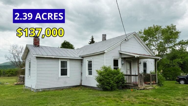 Exterior view of a 1913 home on 2.39 acres with stunning mountain views for sale at $137,000 in Clifton Forge, Virginia