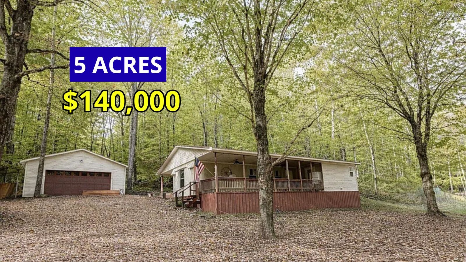 Exterior view of a rustic cabin on 5 wooded acres for sale at $140,000 near the Tennessee River in Waverly, Tennessee