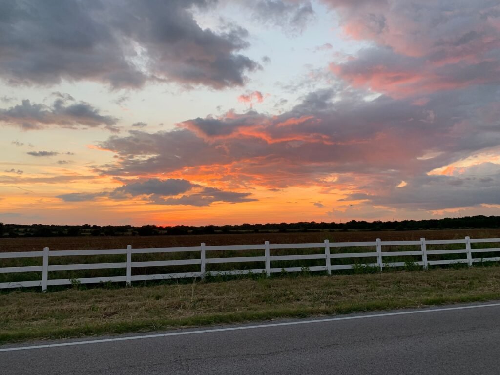 White fence along a pasture at sunset near Belton, Central Texas