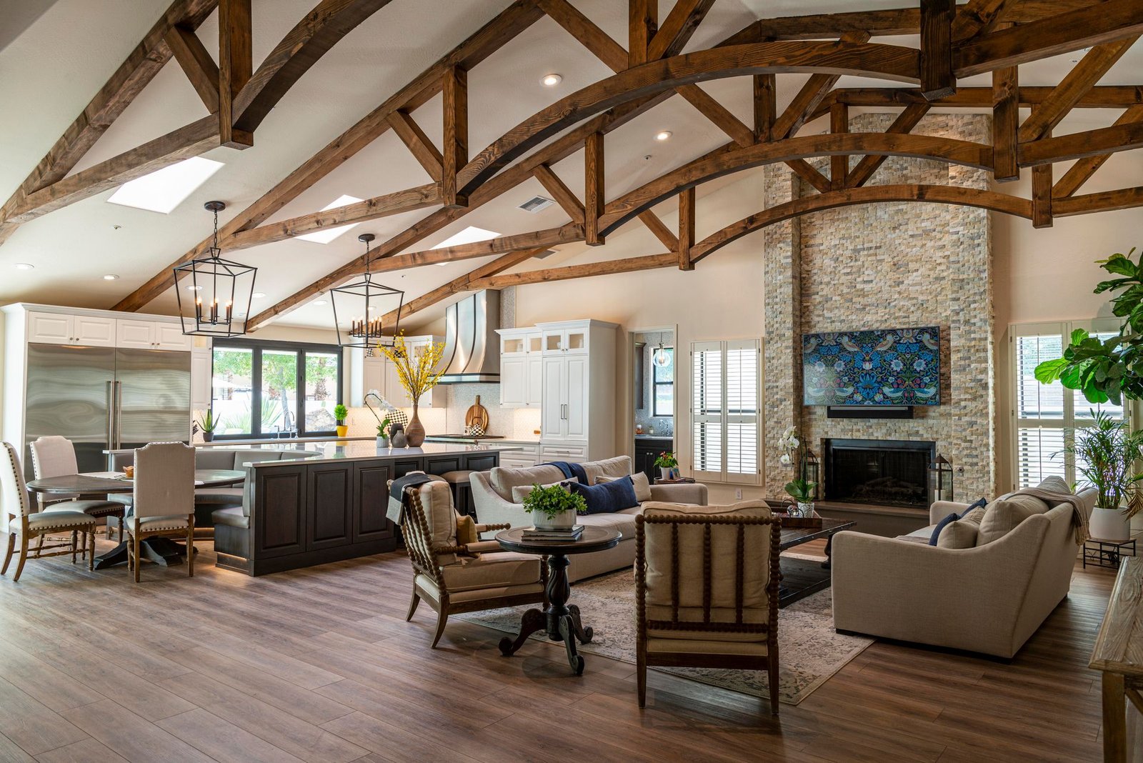 Open-plan living area with a vaulted ceiling and exposed timber trusses
