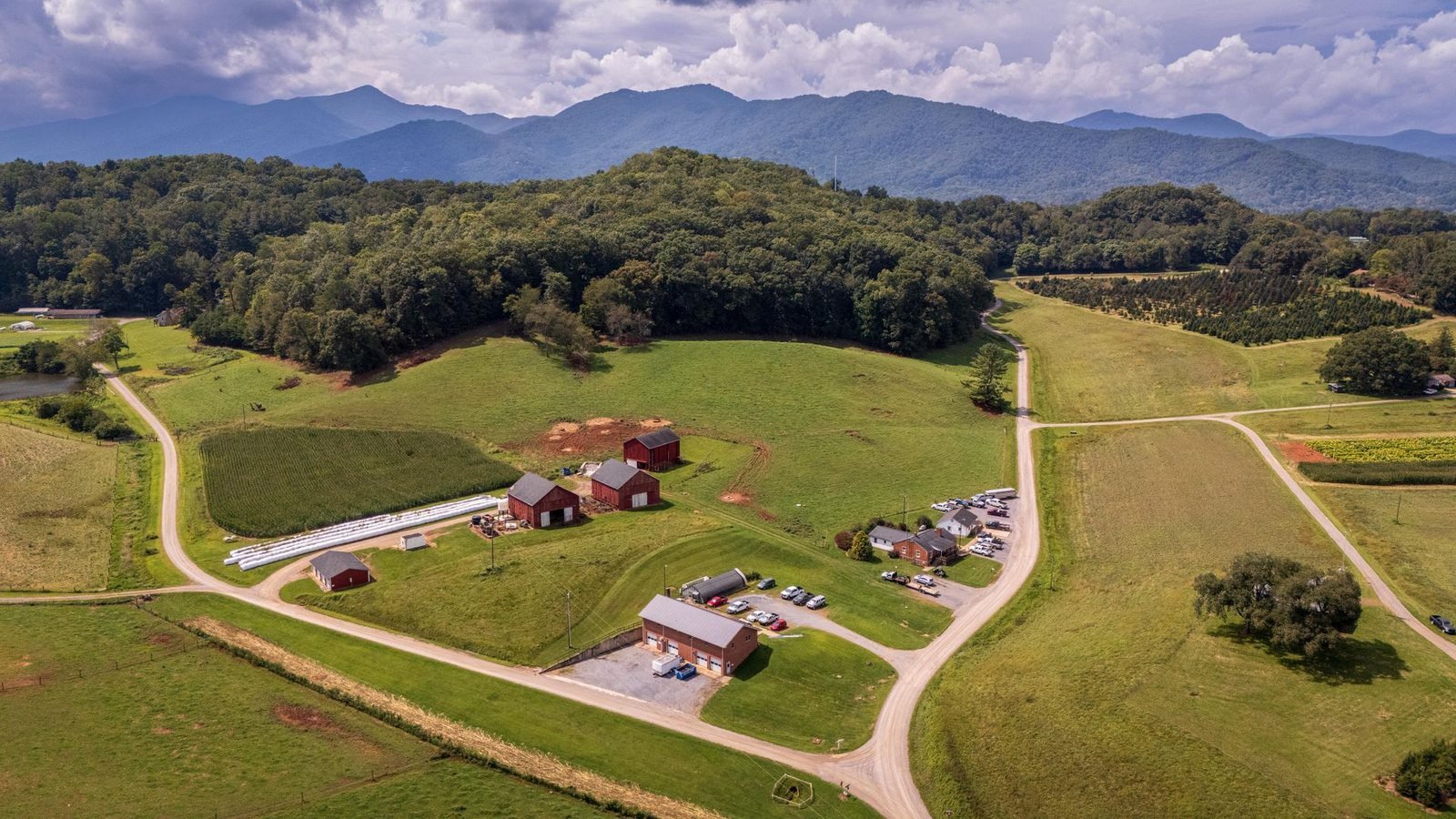 Green pasture, red barns and hayfields below the Blue Ridge, in the rural South where land is cheap to buy and cheap to own