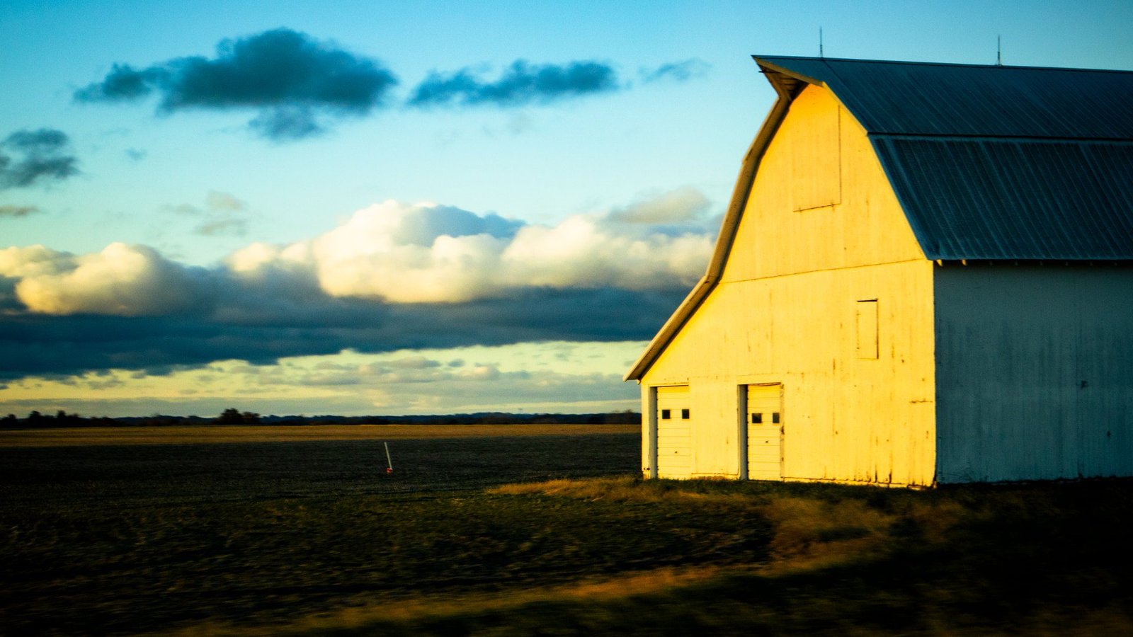 Barn at sunset beside an open field on a rural Missouri farm