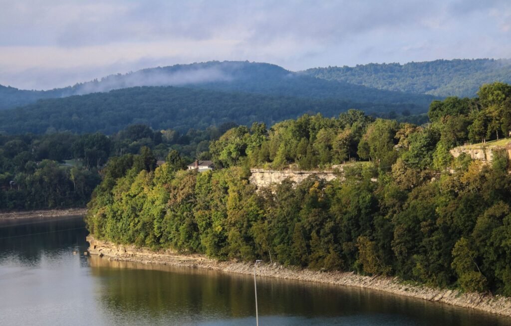 Forested bluffs and a calm lake in the Missouri Ozarks